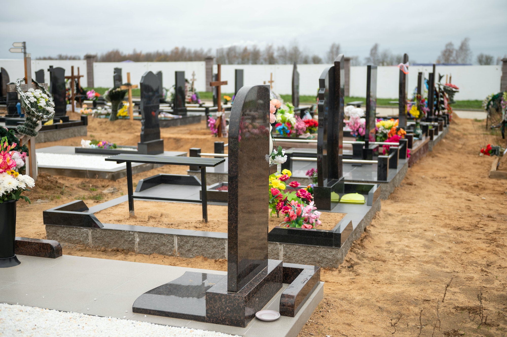 Grave crosses with wreaths in the cemetery on the sand